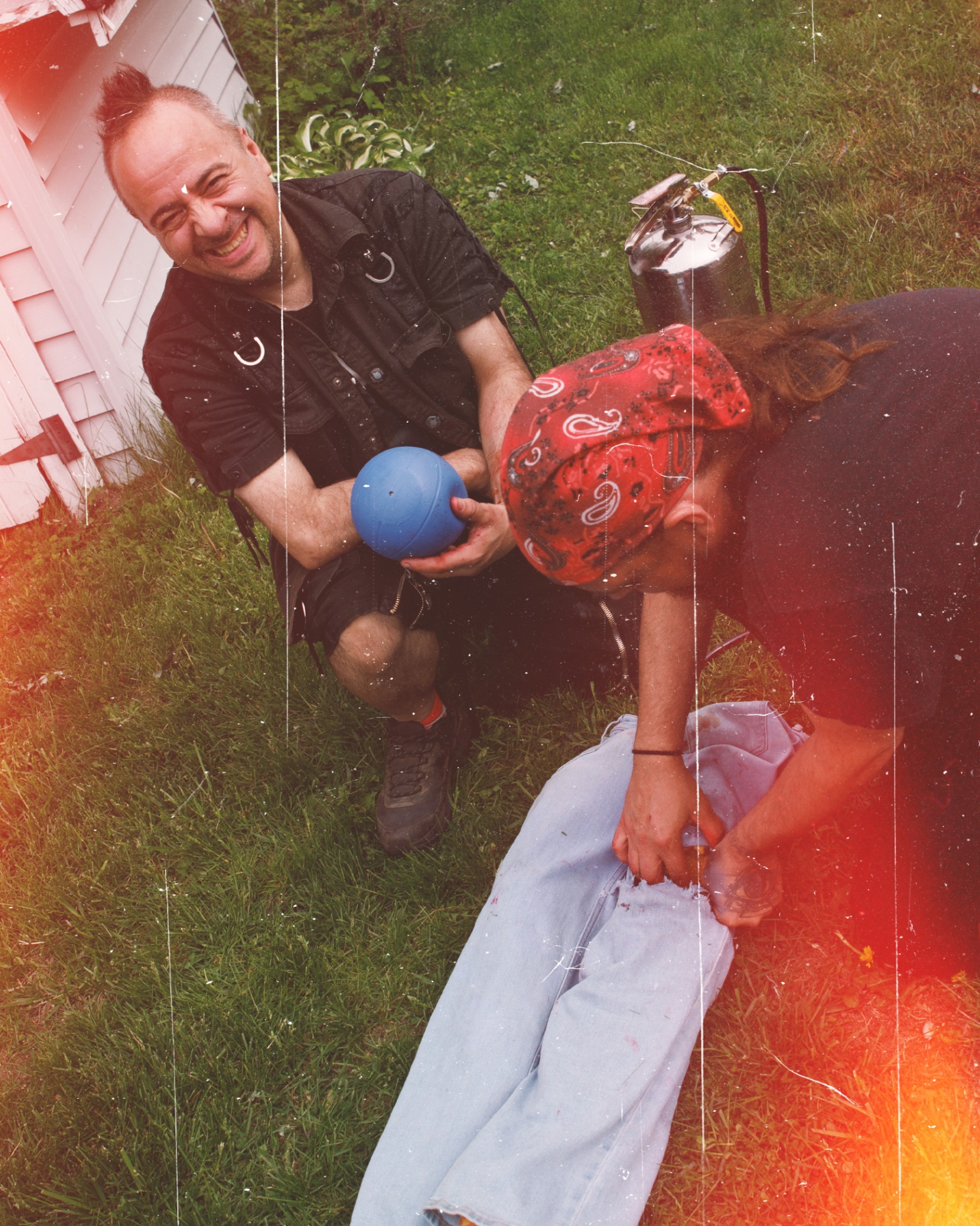 Director laughing on set with a ball and crew