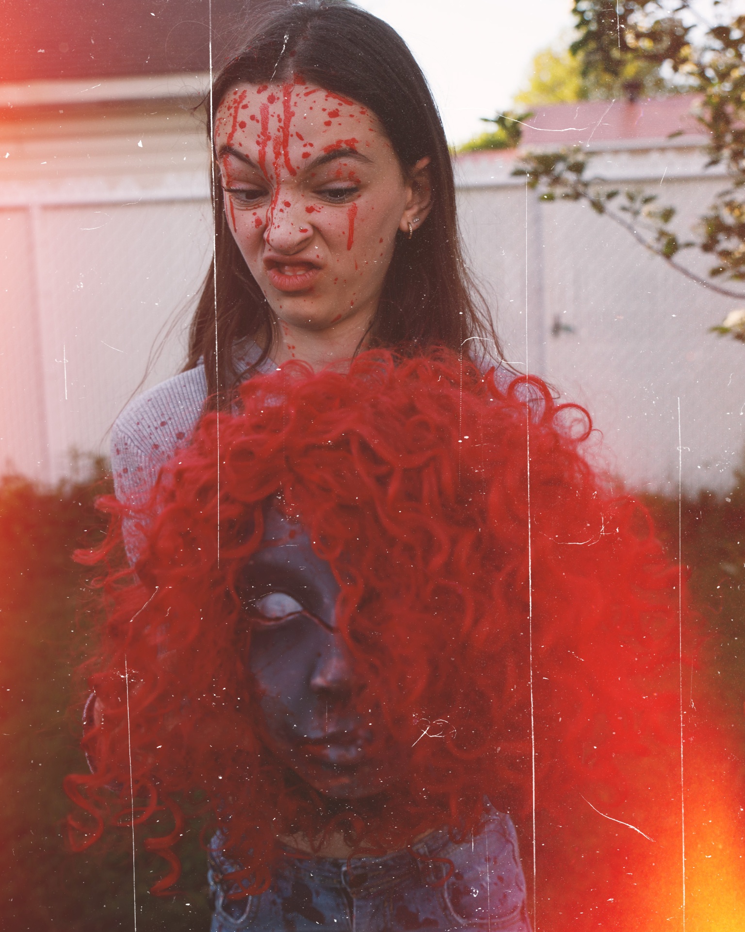 Blood-splattered survivor holding a severed head
