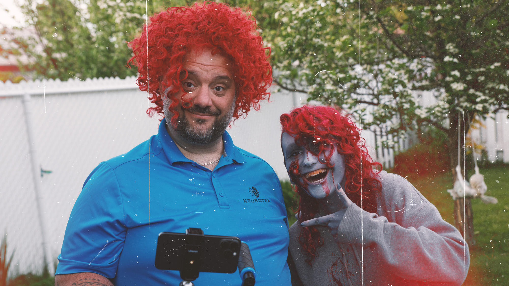 Director in red wig posing with zombie cast member