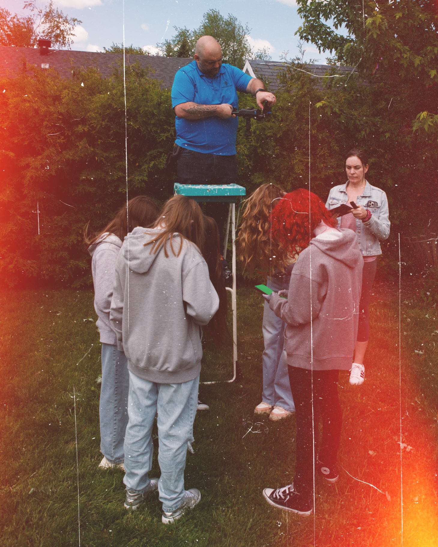 Crew filming the cast in the backyard